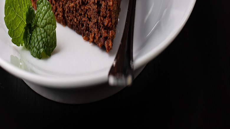 Close up of a slice of chocolate cake on a white plate