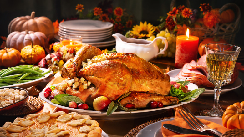 Roasted turkey and other foods on Thanksgiving table.