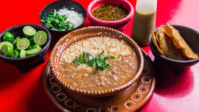 rustic ranchero beans in bowl with accompaniments