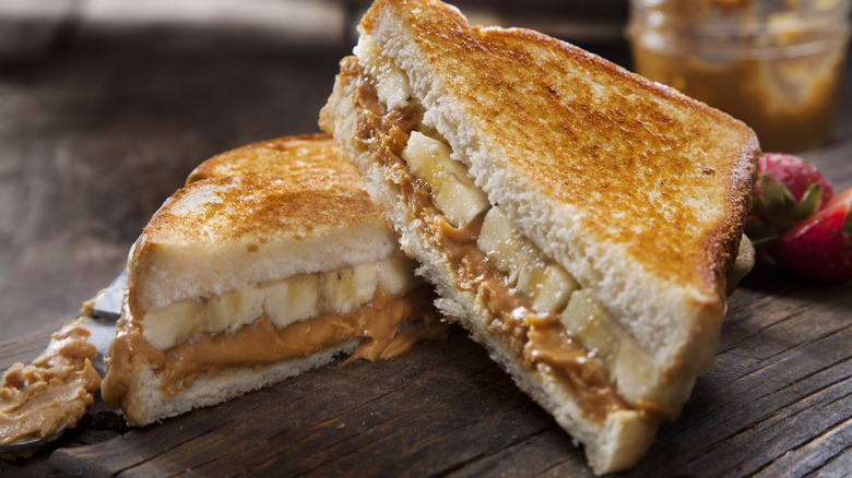 Peanut butter and banana sandwich on wood table