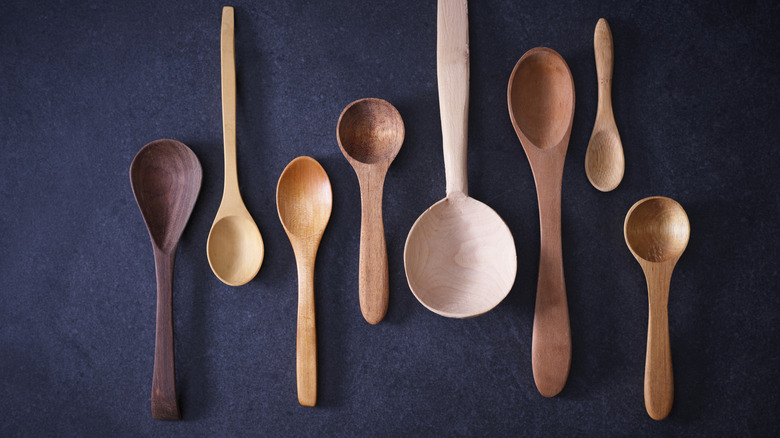 Collection of wooden spoons on dark background