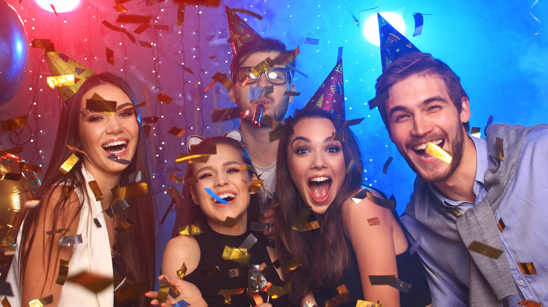 Five people enjoying themselves at a party