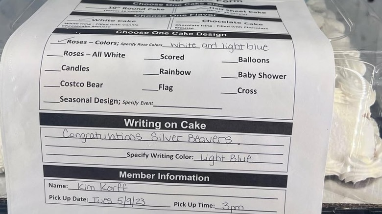 A close-up of an order form taped to a finished Costco custom cake