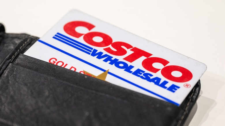 A Costco member card in a black leather wallet on a white background
