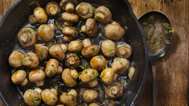 A pan of mushrooms cooking