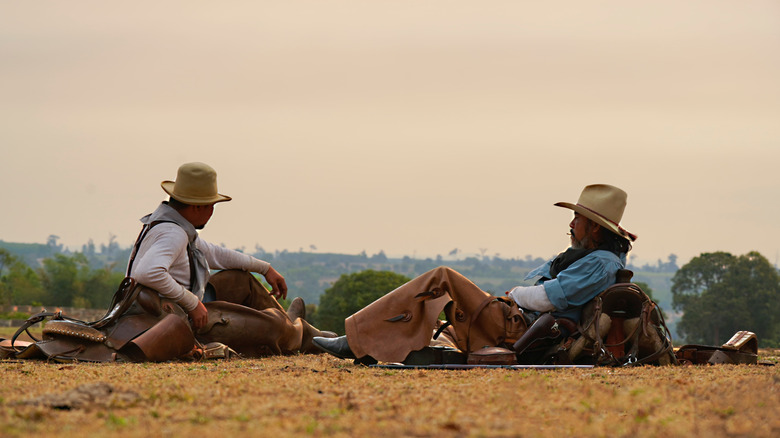 Mexican vaqueros relax outside on ranch