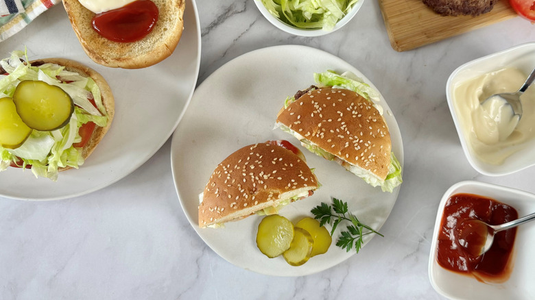 aerial view of two halves of a hamburger on a white plate