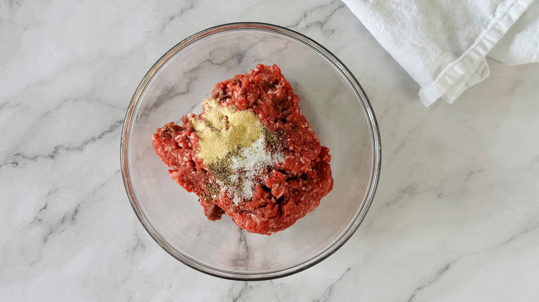 ground meat and seasonings in a clear bowl