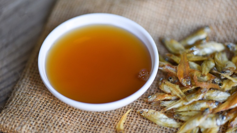fish sauce in saucer next to dried fish