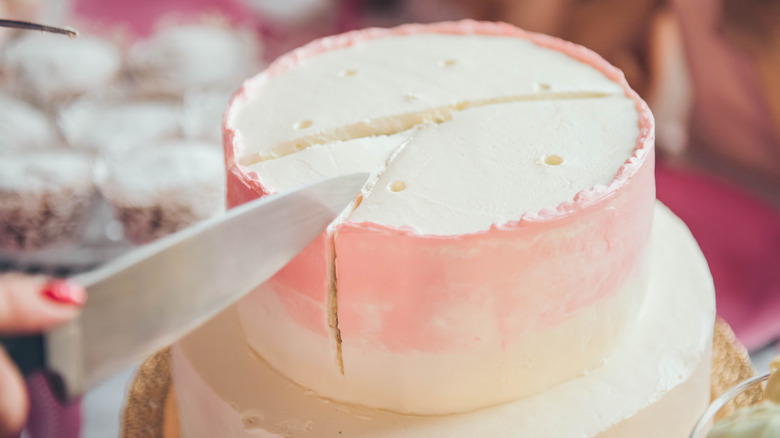 Clean knife slicing through a frosted cake