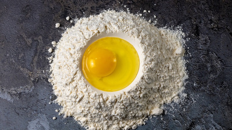 egg in a flour well for pasta-making