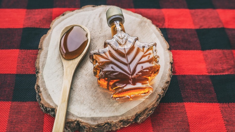 maple syrup and spoon on Buffalo plaid cloth