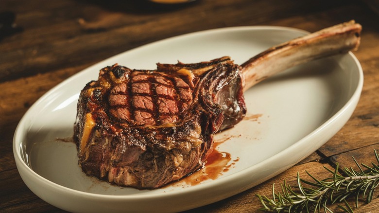 juicy tomahawk steak on platter