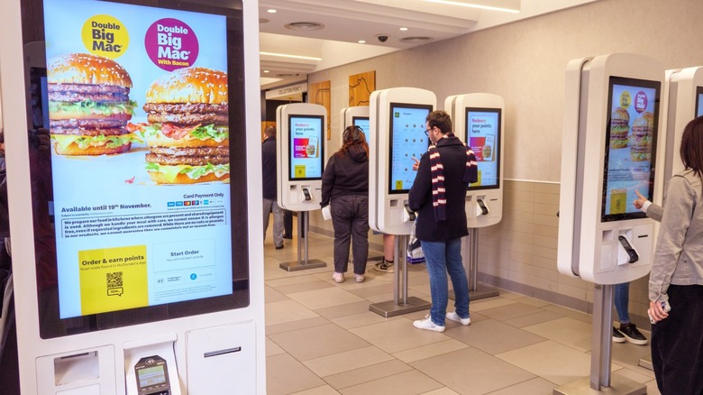customers order mcdonald's on touchscreen kiosks