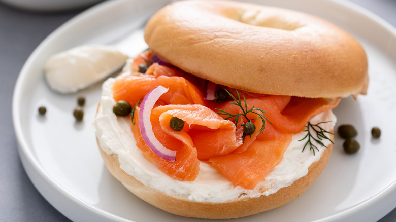 A smoked salmon and cream cheese bagel on a plate