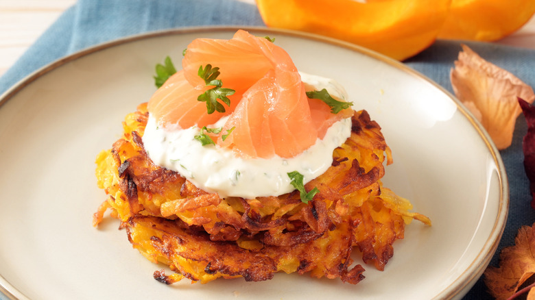 Hash browns topped with cream cheese and salmon