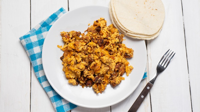 scarmbled eggs with chorizo on plate