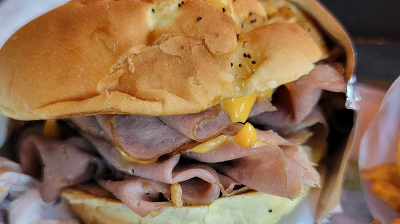 Closeup Arby's roast beef sandwich with cheddar sauce