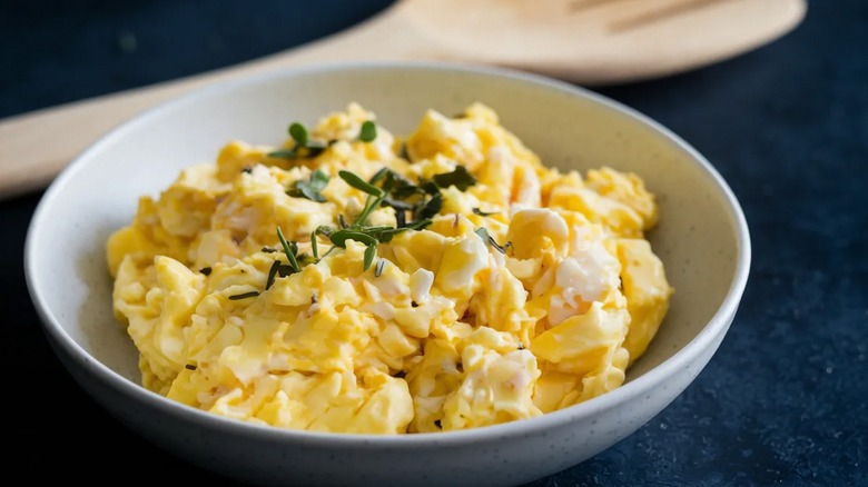 fluffy scrambled eggs in white bowl