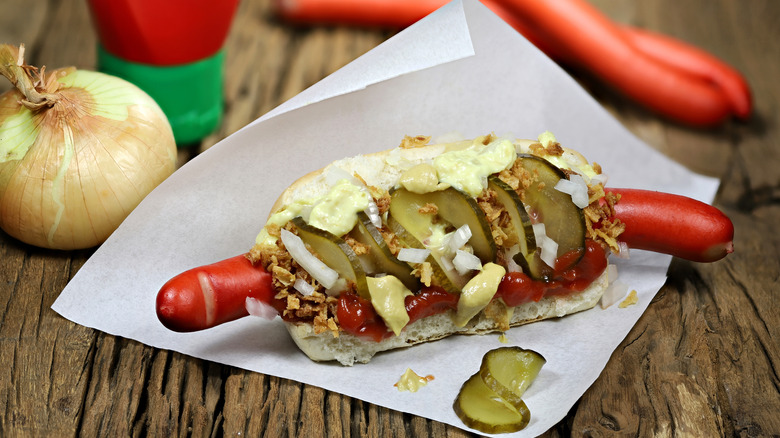 Danish style hot dog with traditional red sausage on a wooden table