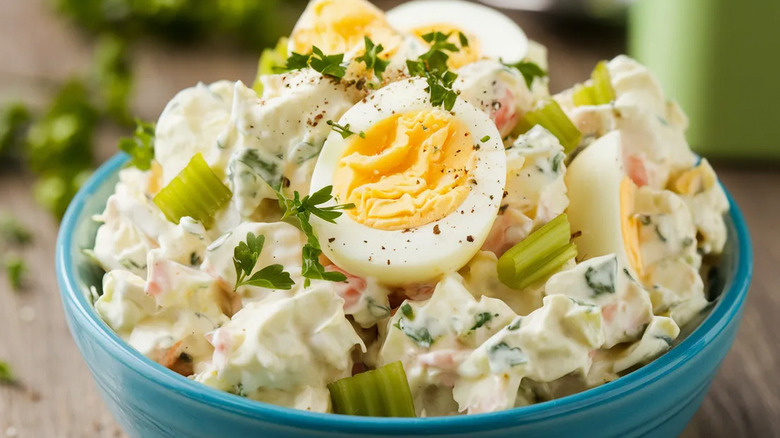 Bowl of classic potato salad with boiled eggs and celery