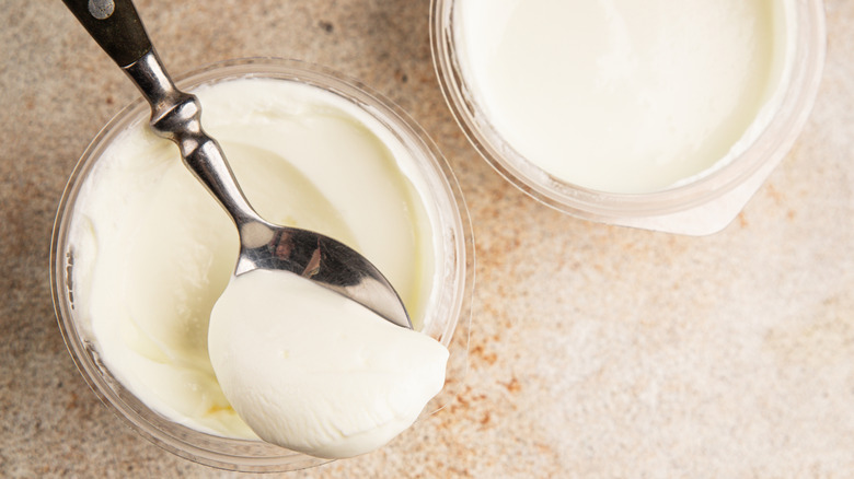 two glass jars with scoop of skyr yogurt
