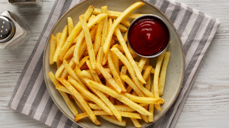 Overhead shot of prepared french fries and ketchup.