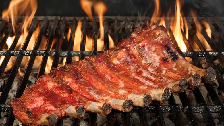 bbq ribs on the grill with flames