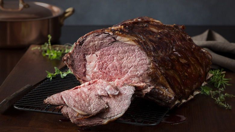 Prime rib sliced open to show medium rare meat