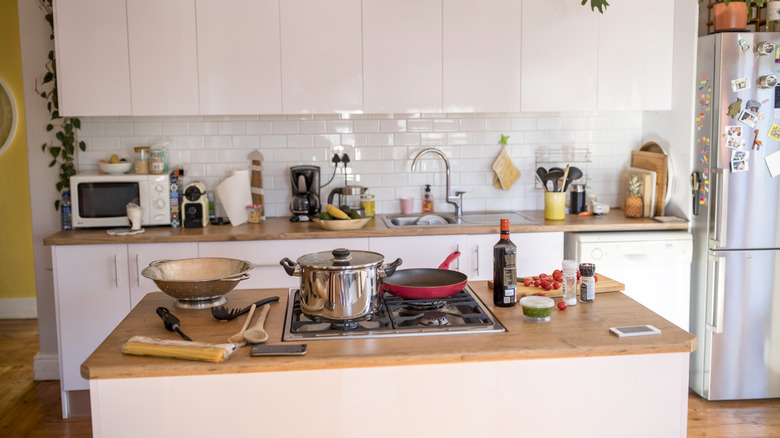 Kitchen with cluttered counters.