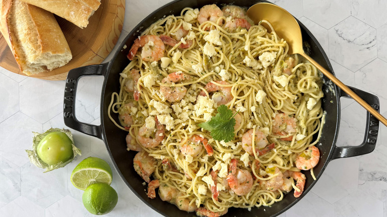garlic prawn and tomatillo pasta in skillet