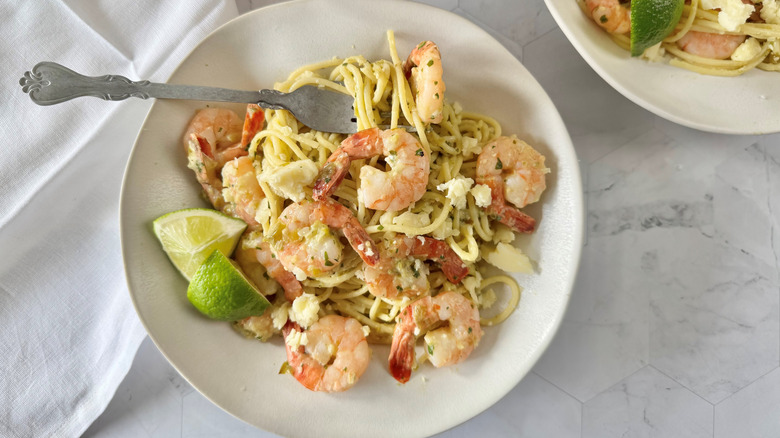 garlic prawn and tomatillo pasta in plate with fork