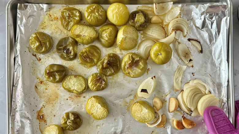 roasted tomatillos, onions, garlic on baking sheet