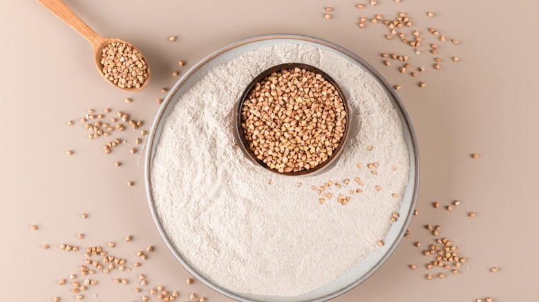 buckwheat kernels atop a dish of buckwheat flour