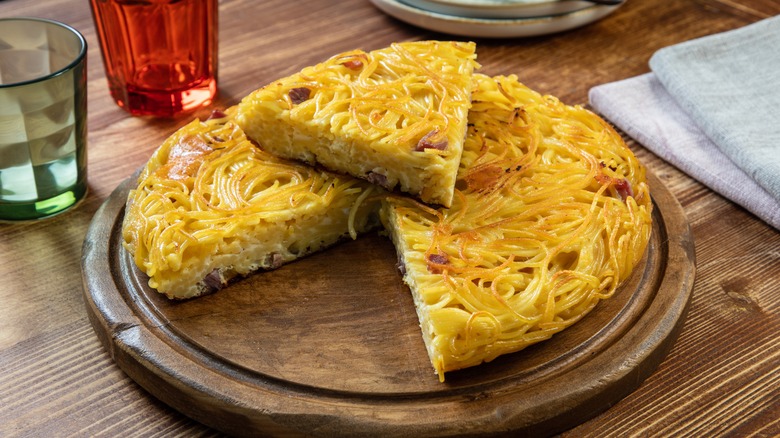 spaghetti pizza with slice cut out