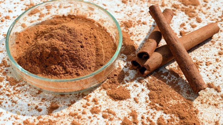 ground cinnamon with intact cinnamon sticks