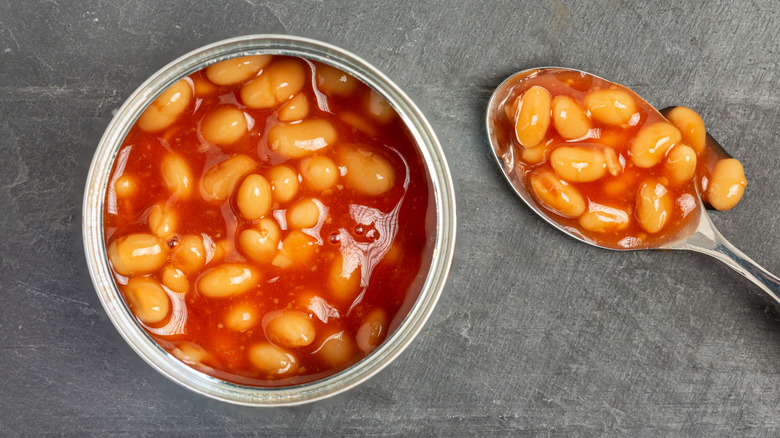 An open can of baked beans and a spoon