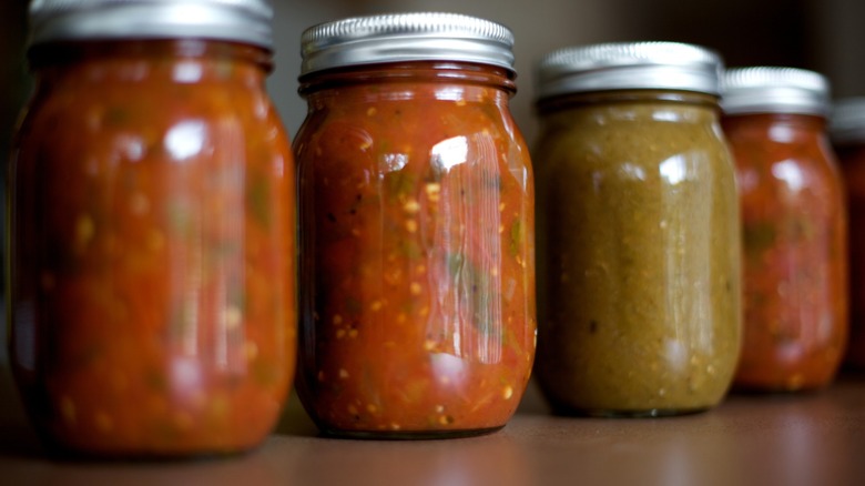 cooked jarred salsa in mason jars on shelf