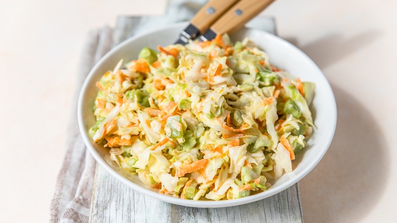 bowl of fresh coleslaw with utensils