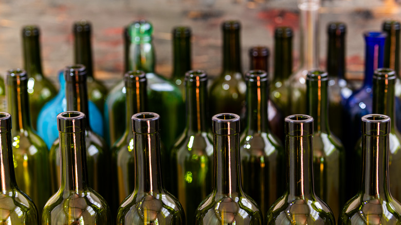 Multiple empty wine bottles standing up