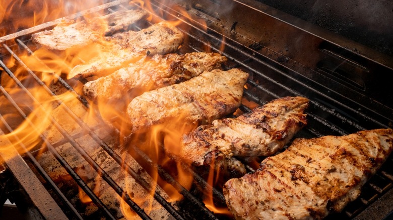 chicken on flaming grill