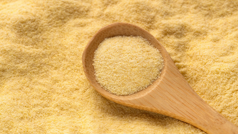 A wooden spoon in durum wheat semolina