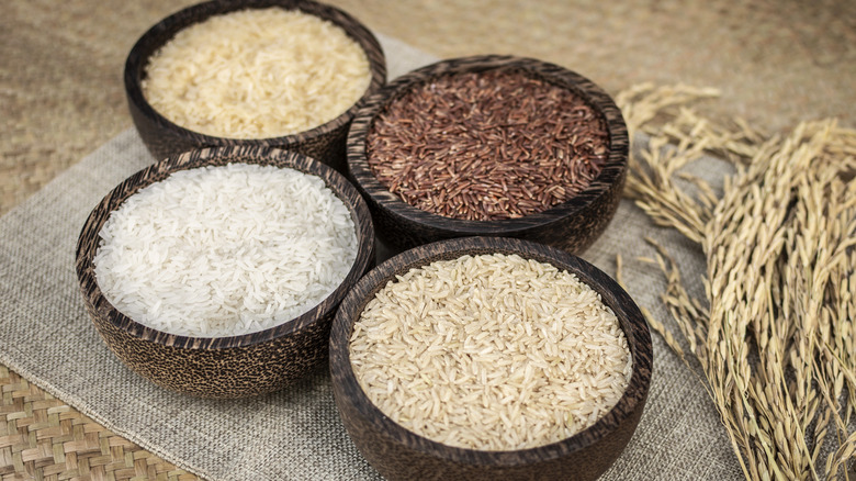 Different kinds of rice in brown bowls