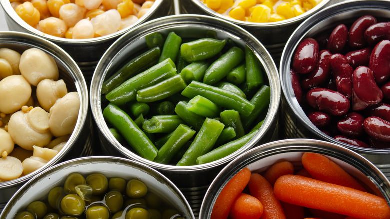 Several open cans of vegetables