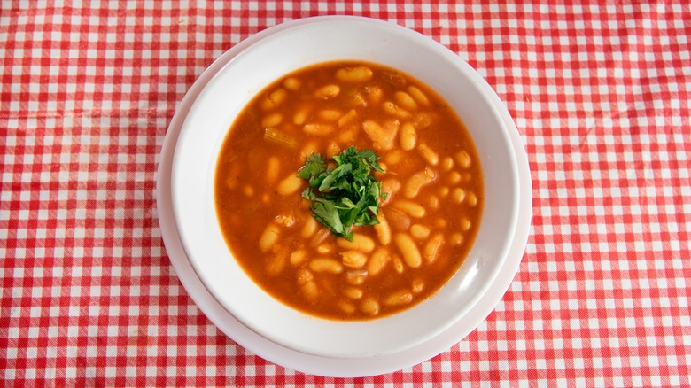 tomato soup with beans on gingham cloth