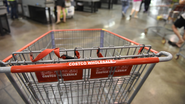 Closeup of Costco-branded shopping cart inside store.