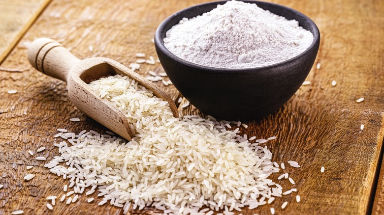 rice flour with wooden spoon of white rice