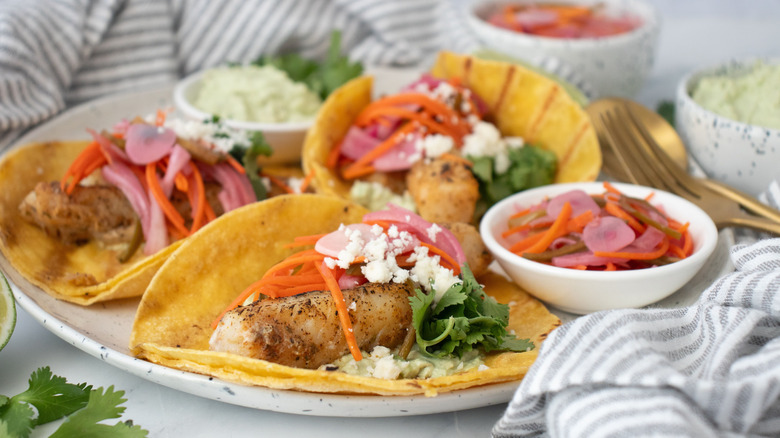 Grilled fish tacos with escabeche on plate