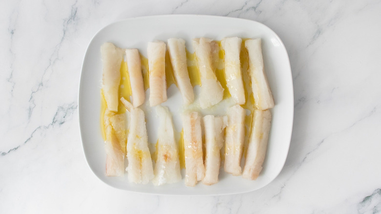 Cod slices drizzled with oil