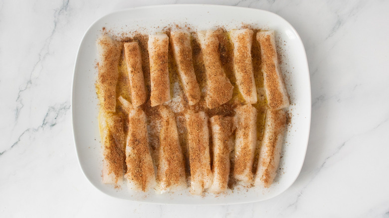 Seasoned cod slices on plate